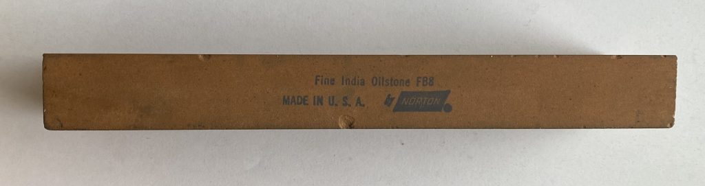 Cleaned India oilstone side view showing label